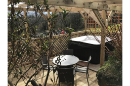 Patio with table and hot tub