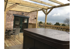 View of patio with cottage behind